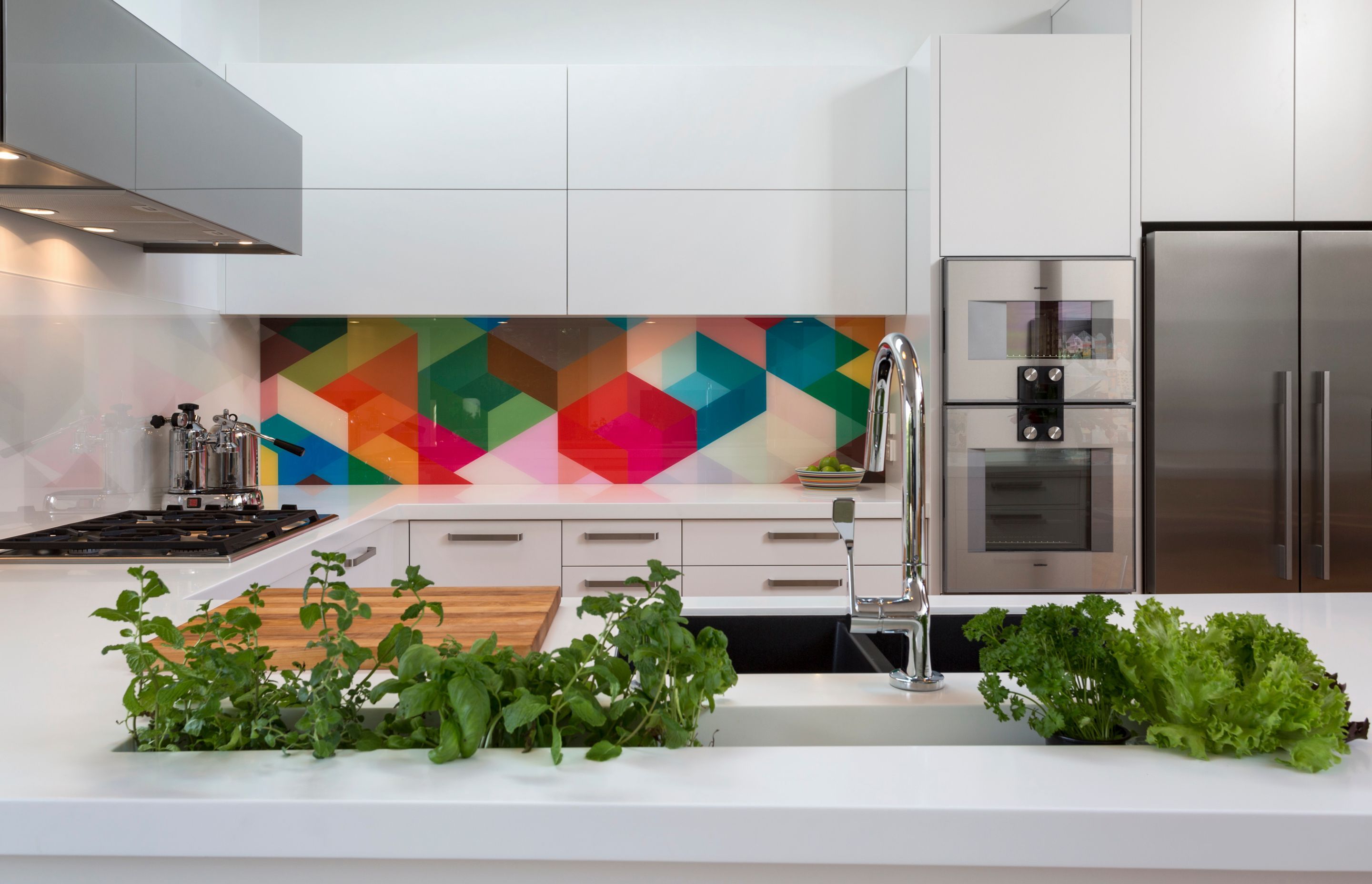 Geometric colour and adjacent geometric monochrome work harmoniously in this white kitchen.  Kitchen by Kitchen Architecture