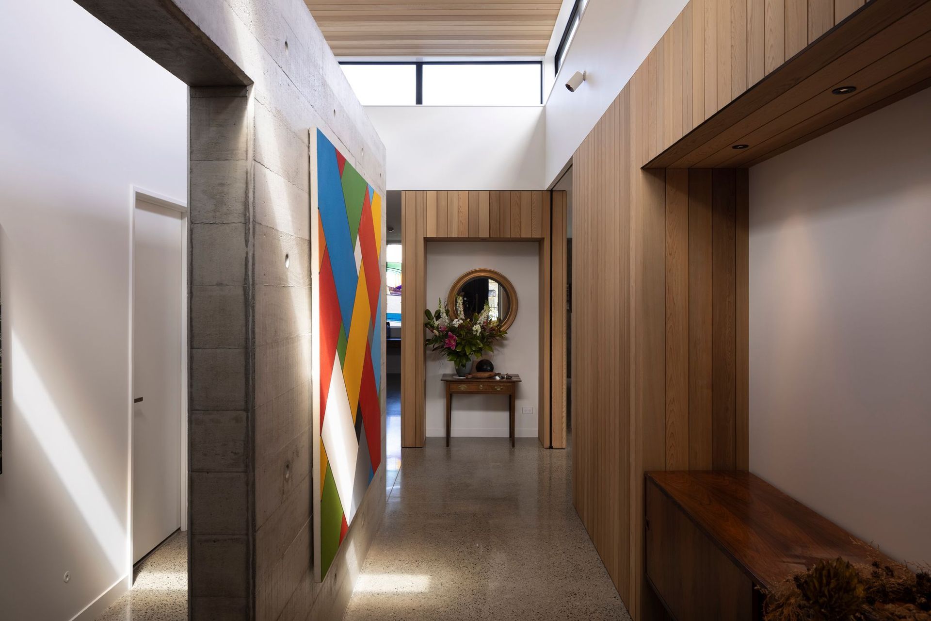 “The clerestory windows really unlock the centre of the house. The stud height is nearly four metres in here, and glazed all around. The concrete wall down the middle is a very strong pivot point between all parts of the house and becomes a gallery space.”