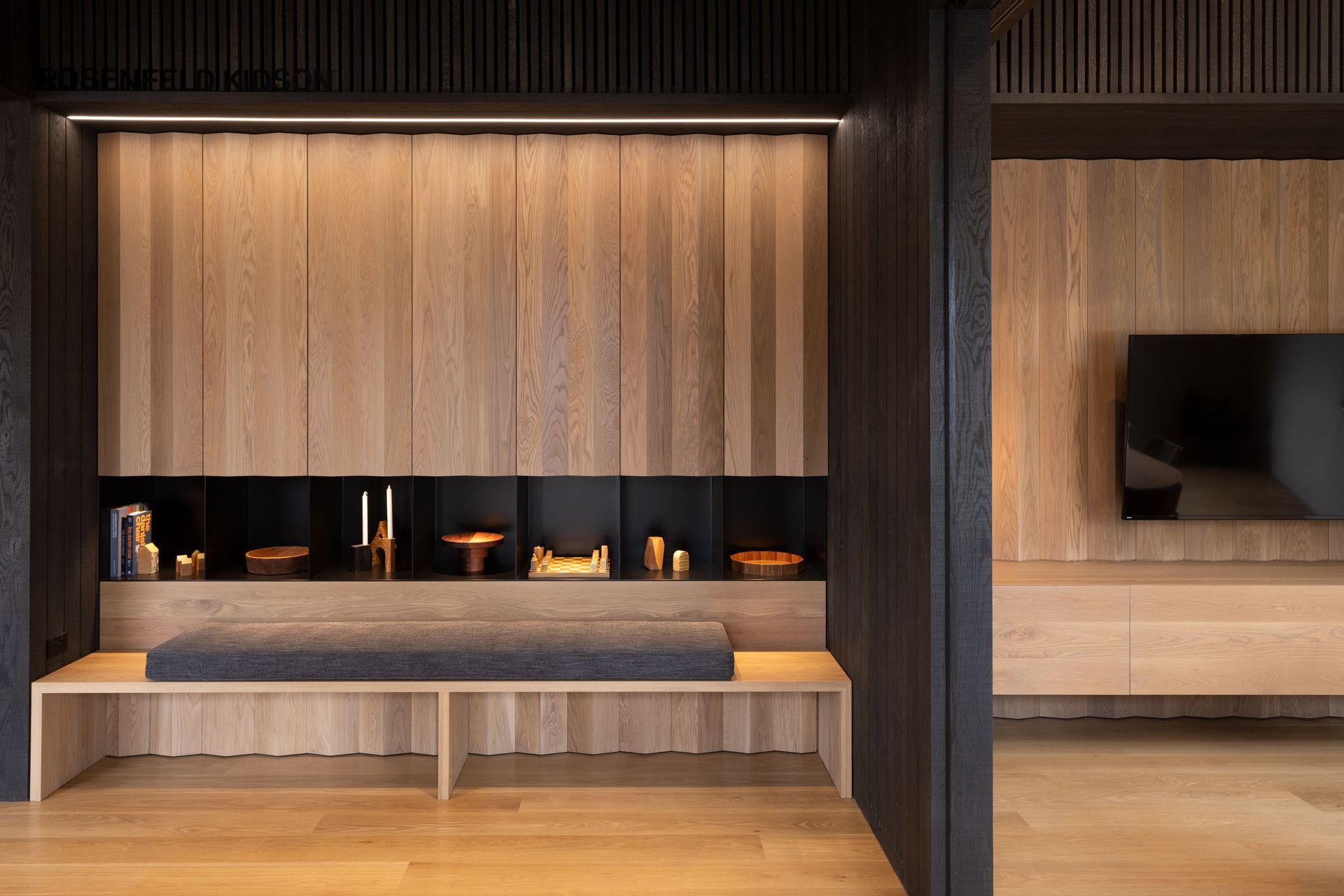 The black painted steel is designed to be recessive and let the turned wood pieces feature.