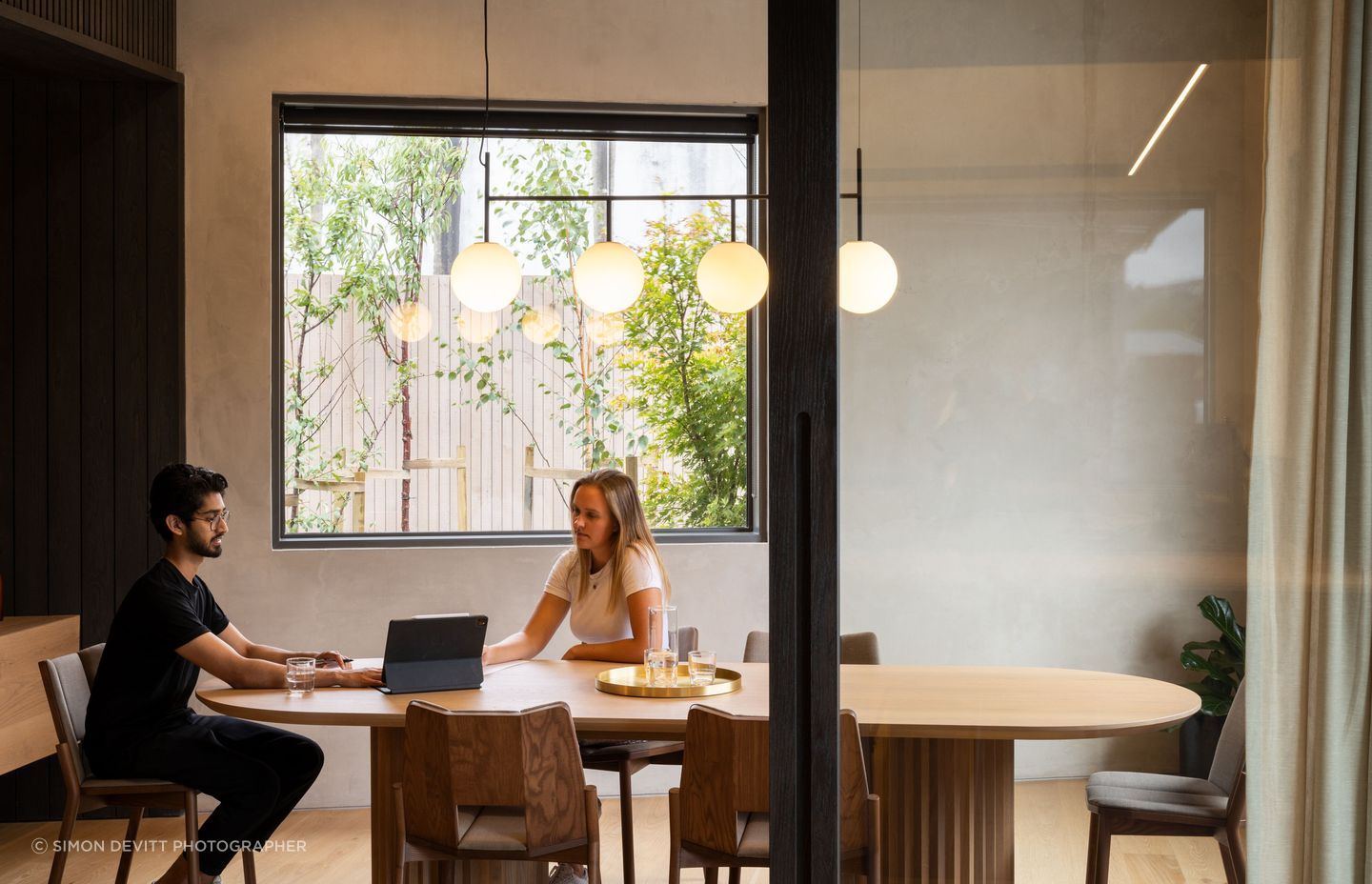 The interior wall is an exposed tilt panel concrete panel that has been rendered. The Menu suspension light is from Simon James.