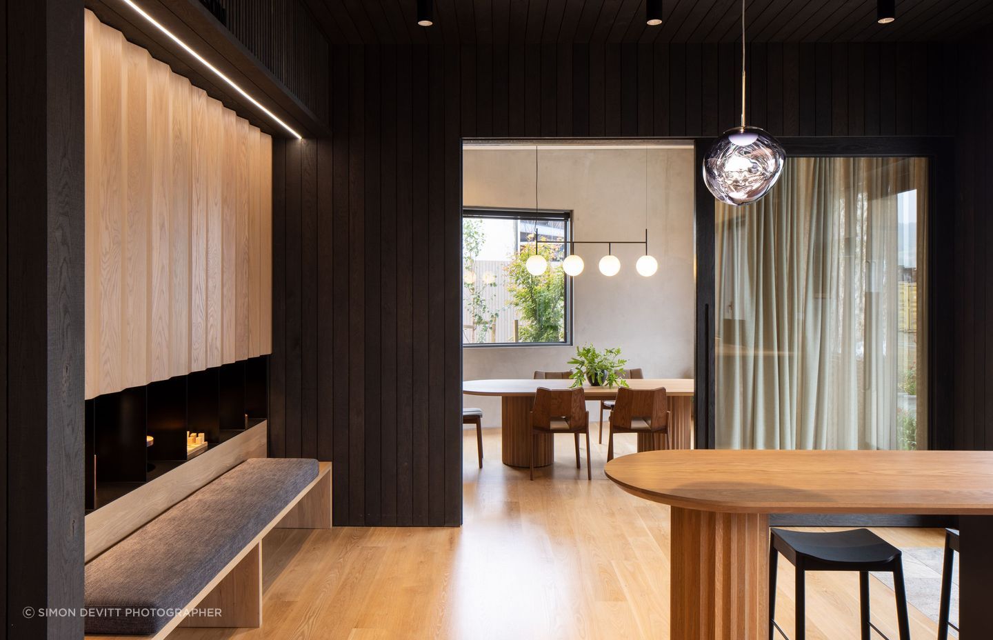 “We were quite careful about furniture that was selected, to complement the custom designed pieces and the oak panelling.” The curtain fabric is James Dunlop and the Tom Dixon Melt pendant is from ECC.