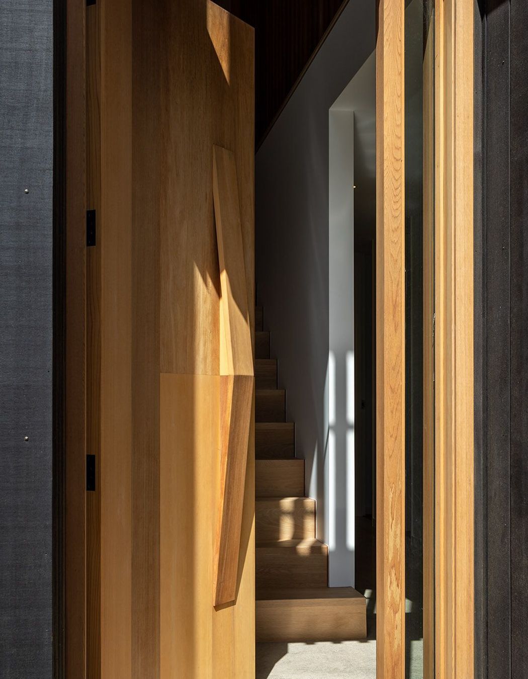 The door opens onto a timber staircase.