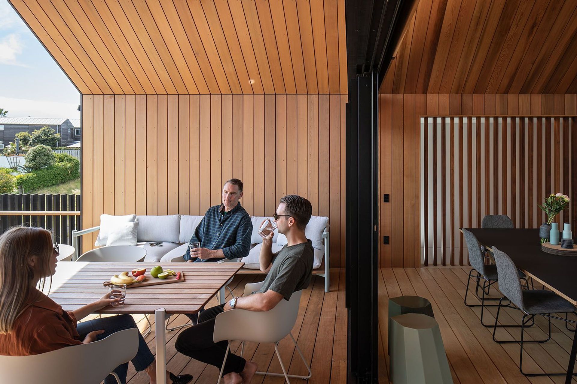 Sliding doors connect the kitchen and living areas to the east-facing covered courtyard.