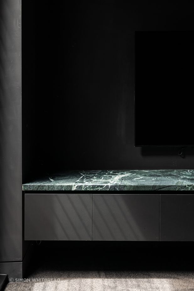 Surrounded by black, the stone's natural veining becomes the focal point.
