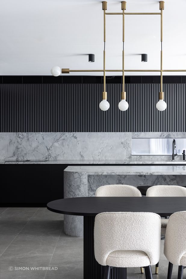 The brass pendant ties in with brass accents found throughout the home – even the feet of the dining chairs.