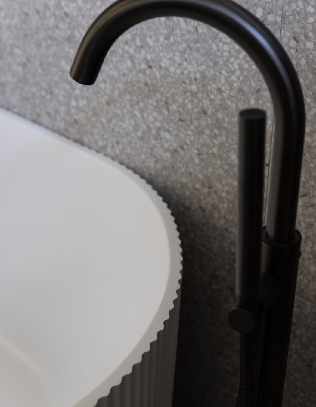 No attention to detail has been spared with the bathtub in the main bathroom a nod to the fluted pattern of the kitchen cabinetry.