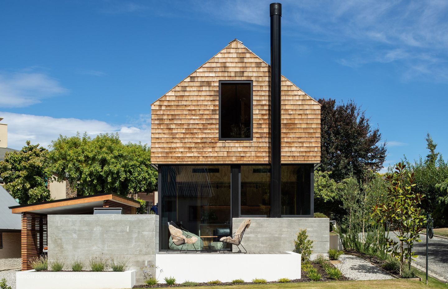 “The palette externally is just cedar and black joinery and then we have a couple of precast concrete elements just to give it a bit of roughness with the cedar,” says Barry. The careful design means there are no gutters or downpipes, retaining the clean detailing.