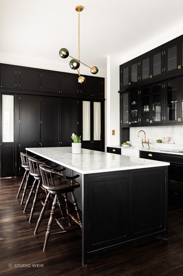 The kitchen design has been influenced by Victorian apothecaries and their use of display cabinetry that towered to the ceiling and was accessed via a ladder.