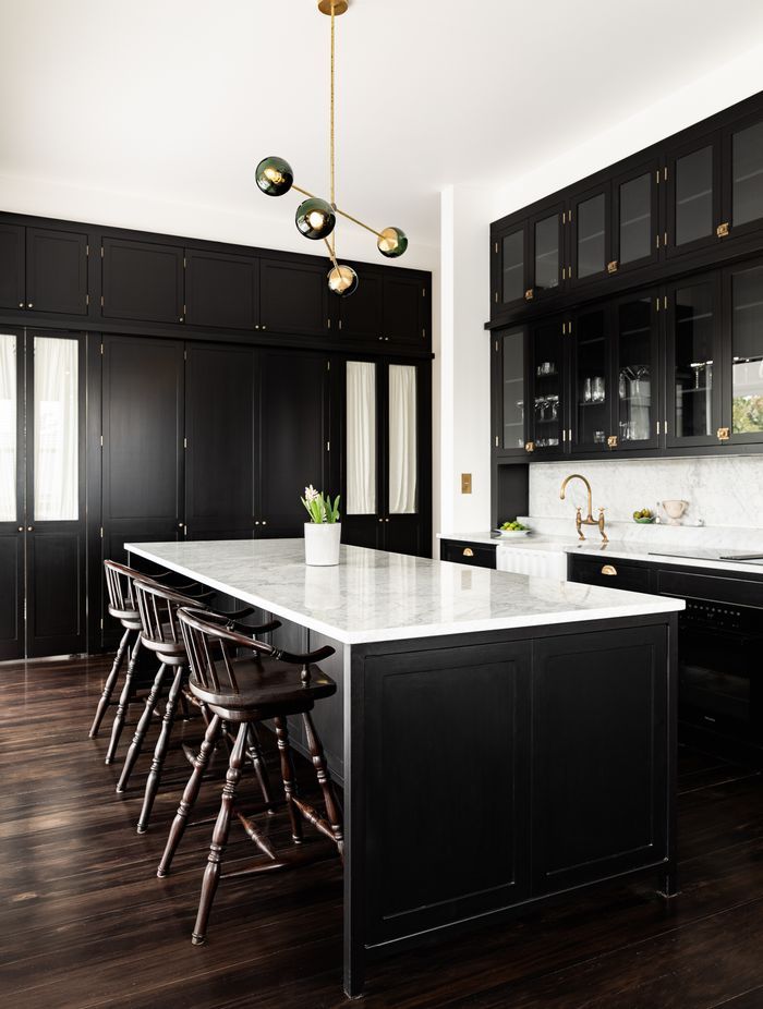 The kitchen design has been influenced by Victorian apothecaries and their use of display cabinetry that towered to the ceiling and was accessed via a ladder.
