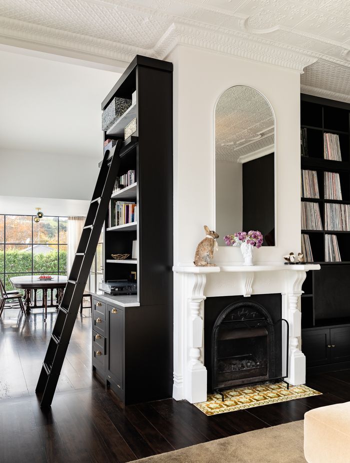 The bespoke timber library with ladder access holds a categorised 1,000+ strong vinyl collection that has been almost 20 years in the making. There is also a laundry chute hidden in cabinetry at the base of the bookshelf.