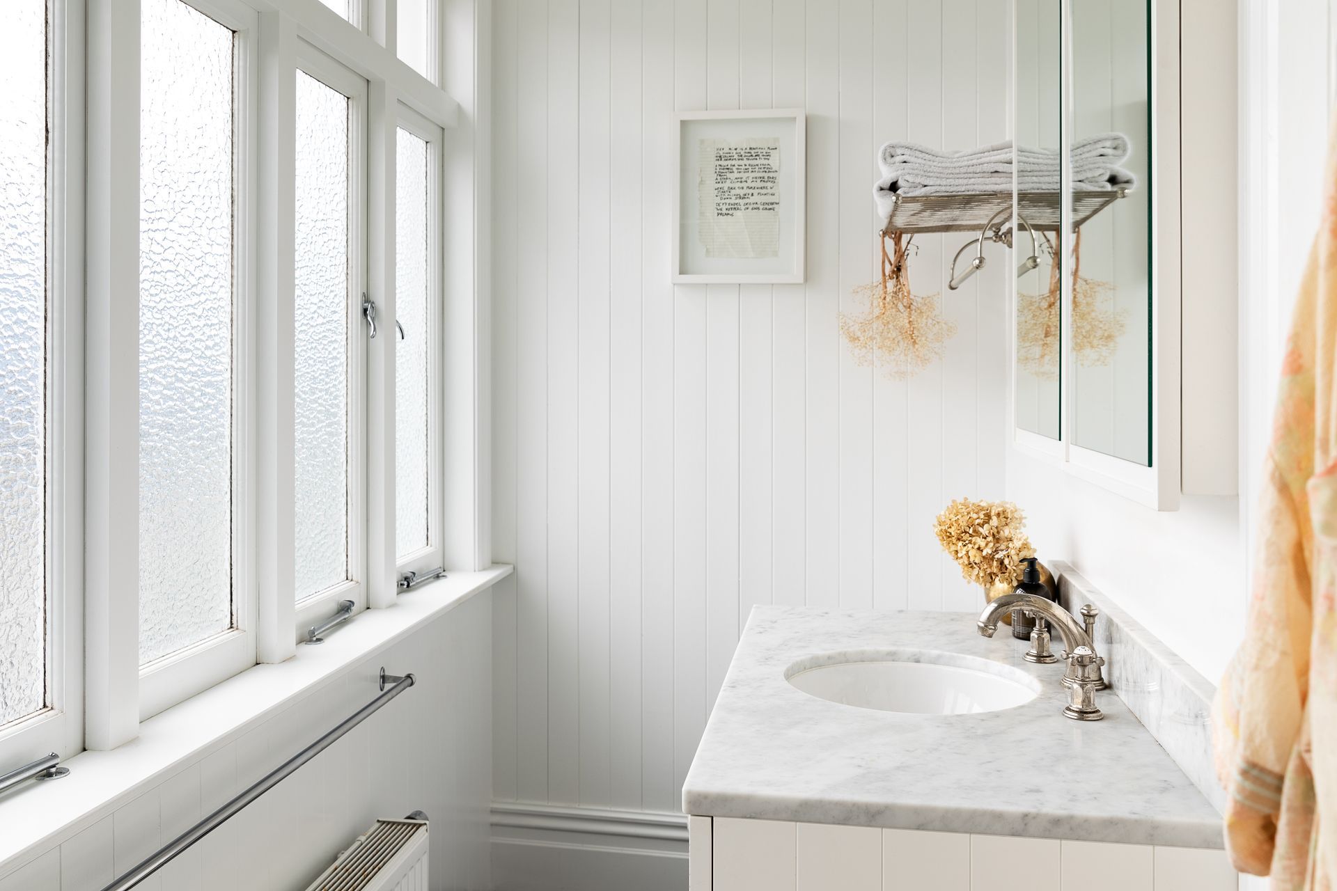 The renovated master ensuite is bright and airy with high ceilings, a marble counter and Perrin &amp; Rowe tapware.