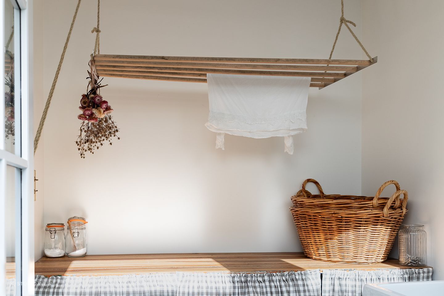 The laundry bench was made by German Kitchens out of old doors found under the house. The laundry skirt is by Island Interiors.
