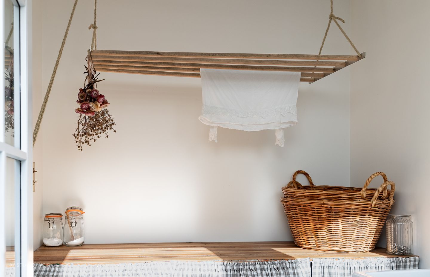 The laundry bench was made by German Kitchens out of old doors found under the house. The laundry skirt is by Island Interiors.