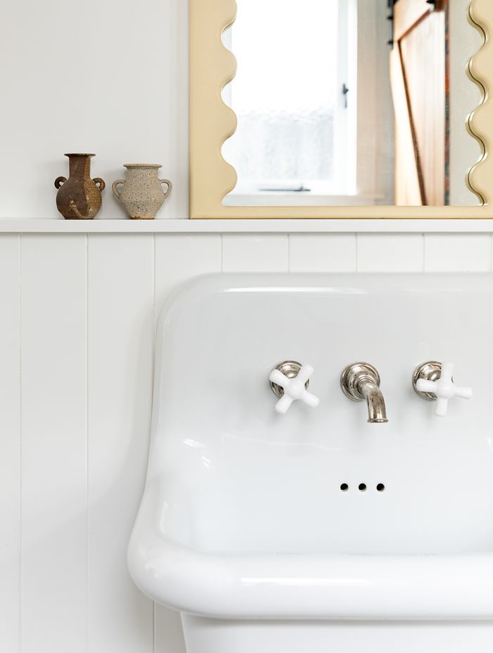 No attention to detail has been spared, with Perrin &amp; Rowe tapware also used in the downstairs bathroom and the curved mirror detailing a nod to the mirror in the children's bathroom.