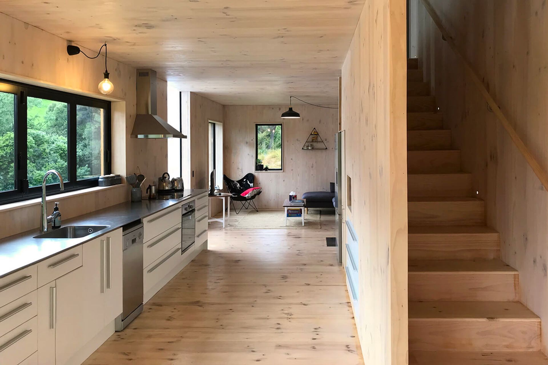 Practical features like the stainless steel benchtop and stairwell storage make this a stylish and functional space