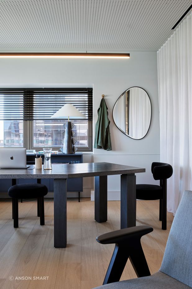 The warm timber floors of the office space juxtapose beautifully against the dark, sculptural furniture.
