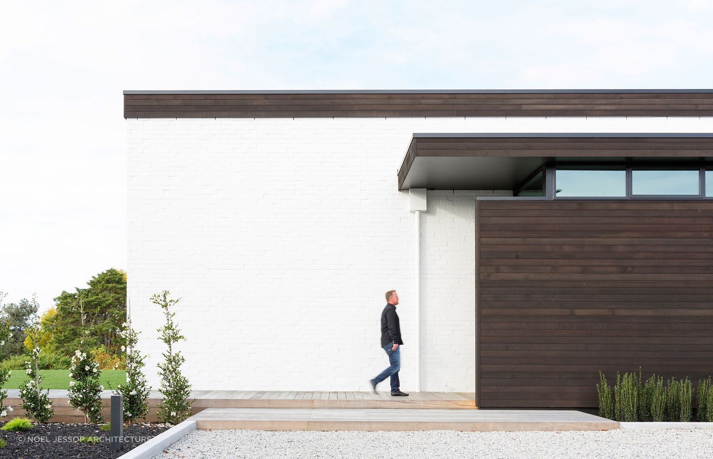 Black stained cedar against white brick cladding makes a fantastic pairing for the Black and White home on the banks of the Waikato River.
