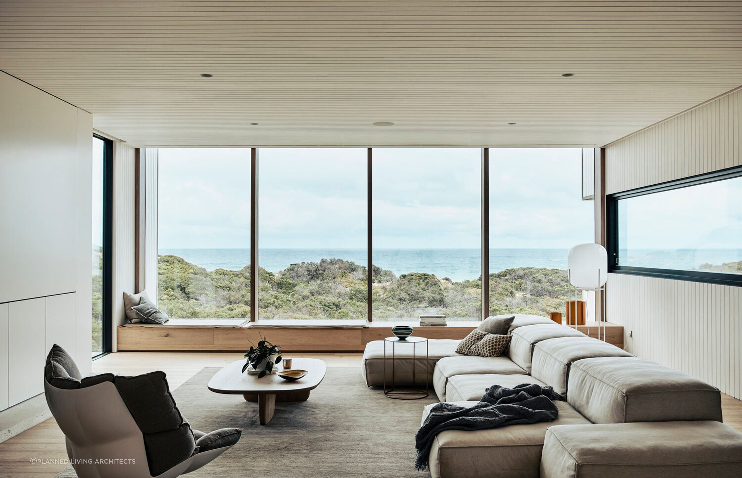 The stunning living room provides picturesque views of the surrounding sand dunes. Photography: Derek Swalwell.