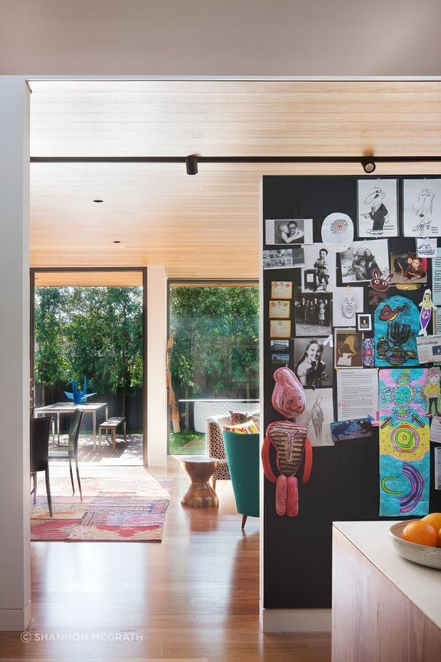 The big family pinboard at Kate's House kitchen keeps art and notices all contained in a fun display