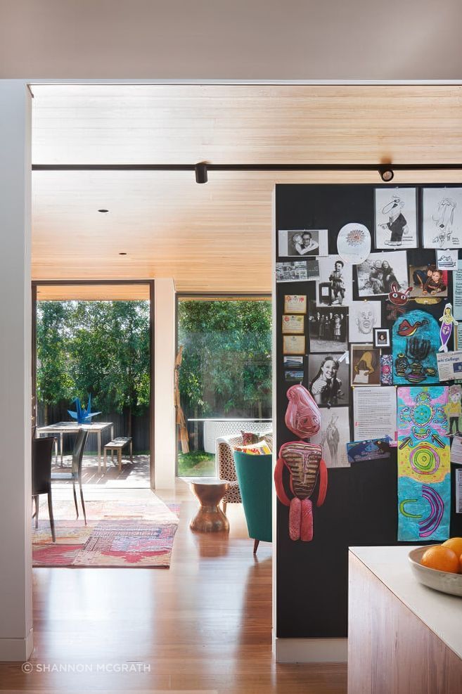 The big family pinboard at Kate's House kitchen keeps art and notices all contained in a fun display