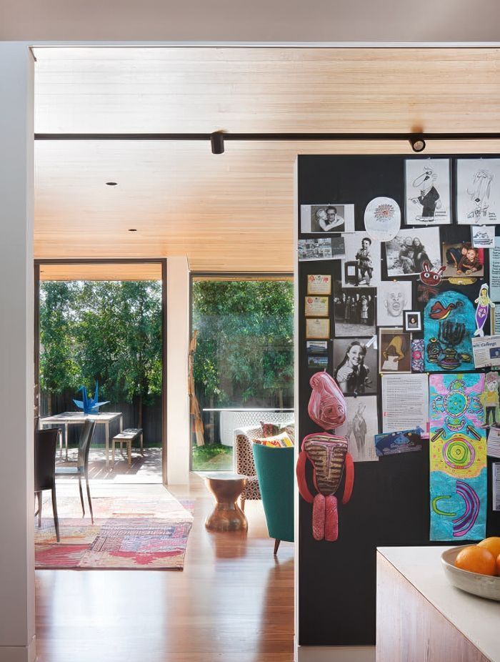 The big family pinboard at Kate's House kitchen keeps art and notices all contained in a fun display