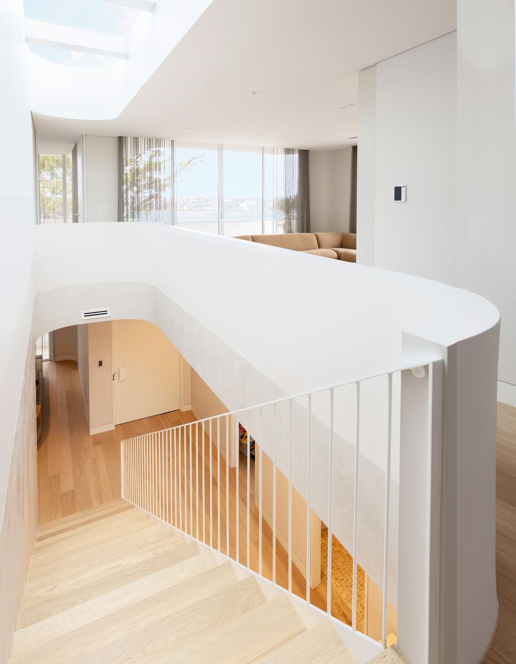 The curve wraps around upstairs to a second lounge area.