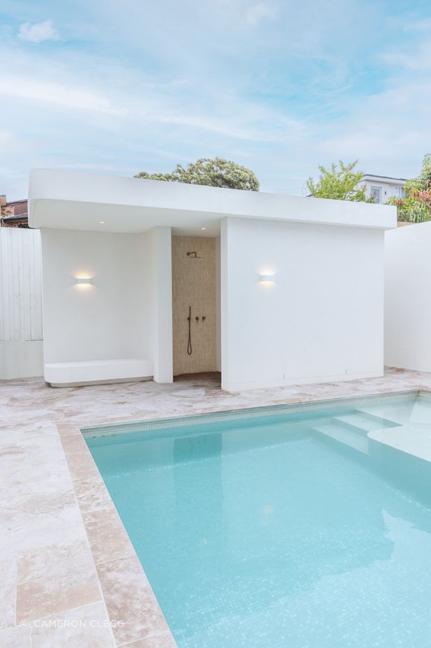 The home also features a stunning outdoor space, complete with a pool and bathroom/change area.