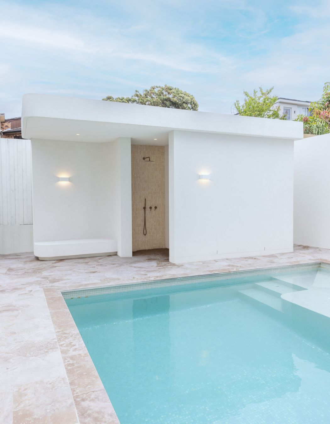 The home also features a stunning outdoor space, complete with a pool and bathroom/change area.