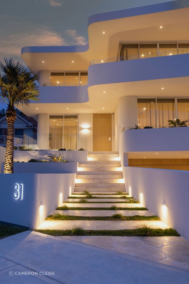 The modern curved facade sets the tone for a contemporary living space that effortlessly blurs the lines between indoors and outdoors.