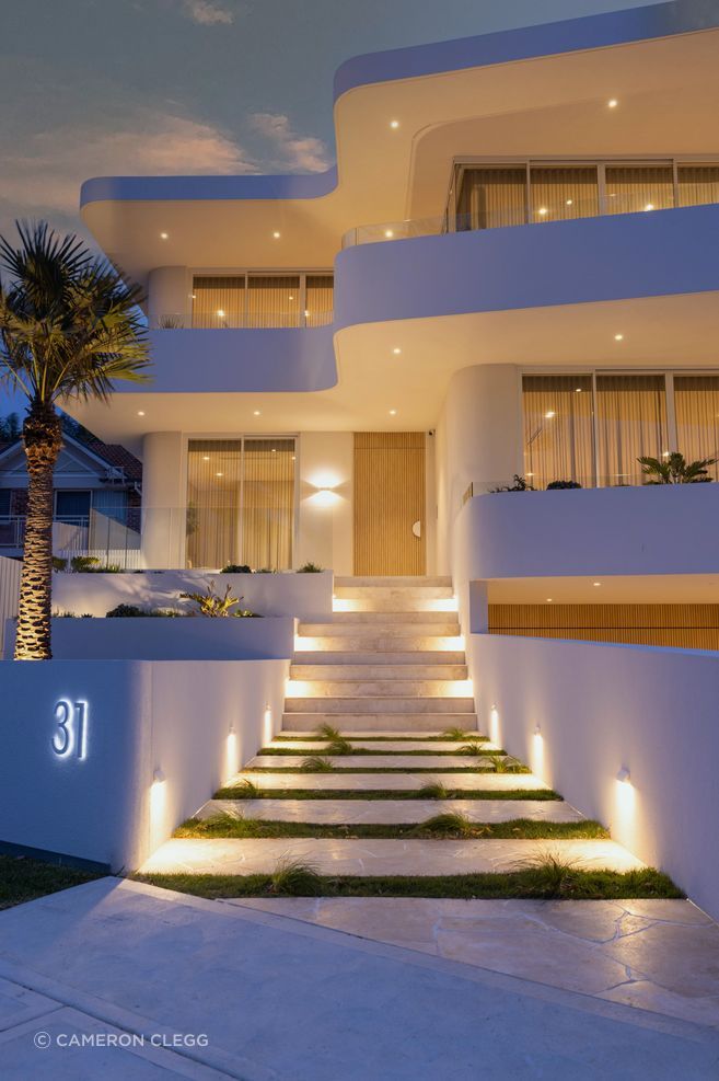 The modern curved facade sets the tone for a contemporary living space that effortlessly blurs the lines between indoors and outdoors.