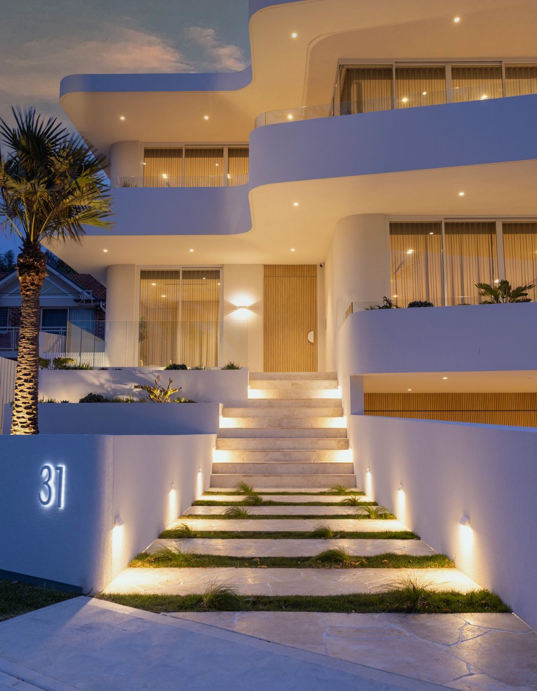 The modern curved facade sets the tone for a contemporary living space that effortlessly blurs the lines between indoors and outdoors.