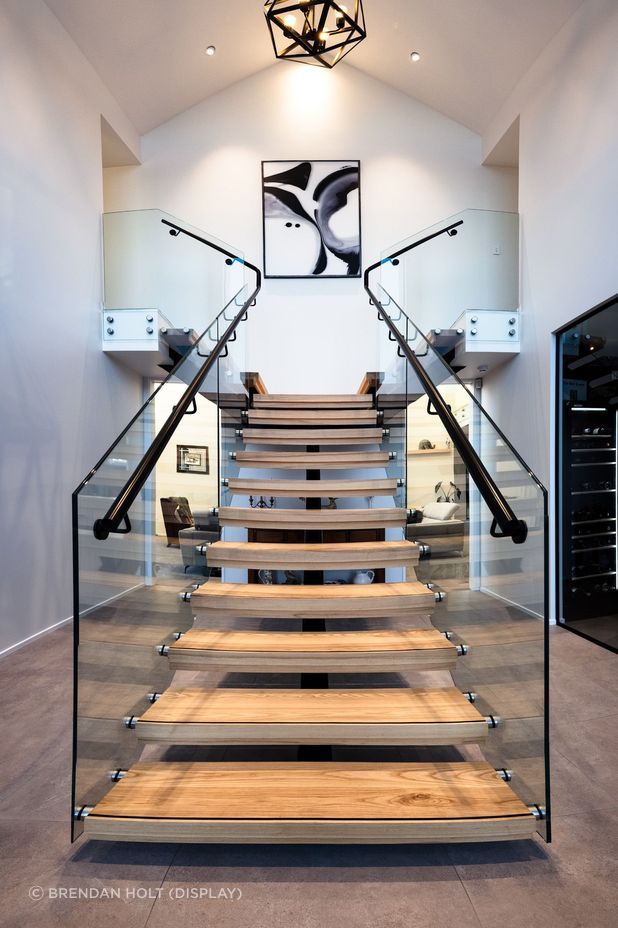 Floating timber stair treads add texture and warmth to the foyer area.