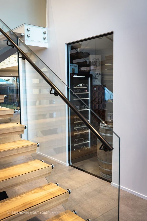 Answering the brief to be an 'entertainer's home', the entrance is complete with a wine cellar for the homeowner's impressive collection.