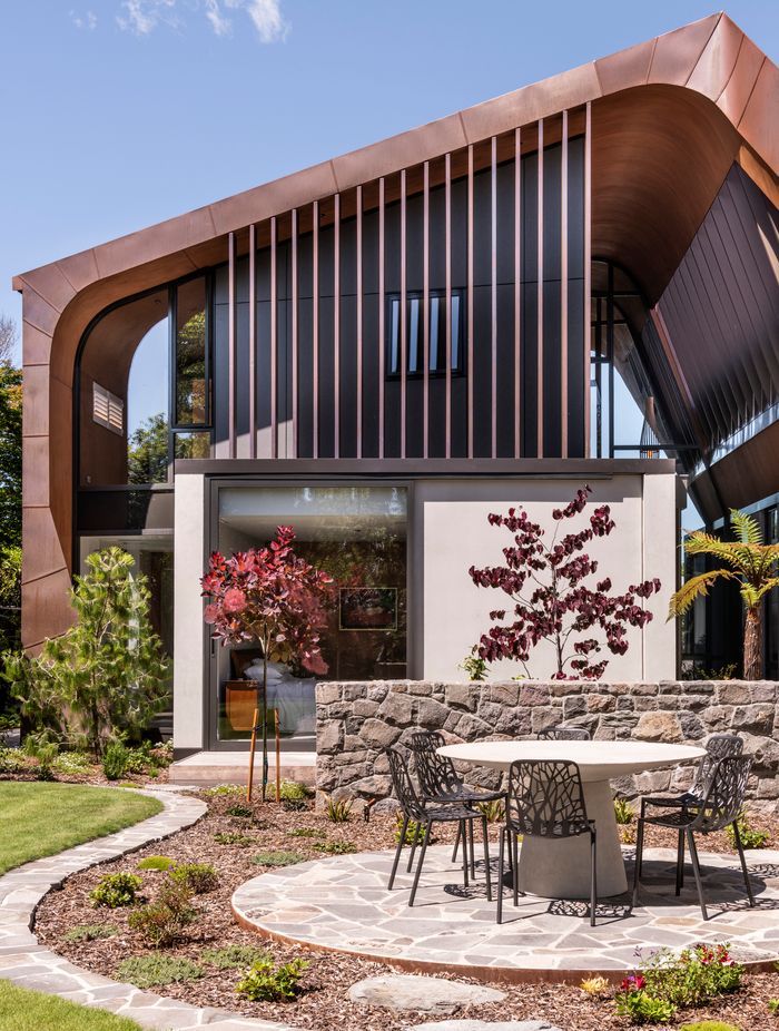 “The clients were wanting something durable, and the concrete and copper will both age naturally and potentially last for hundreds of years. Longevity of the home was part of the brief. We tried to get the concrete as white as we could then had the dark upper floor to really highlight the copper.”