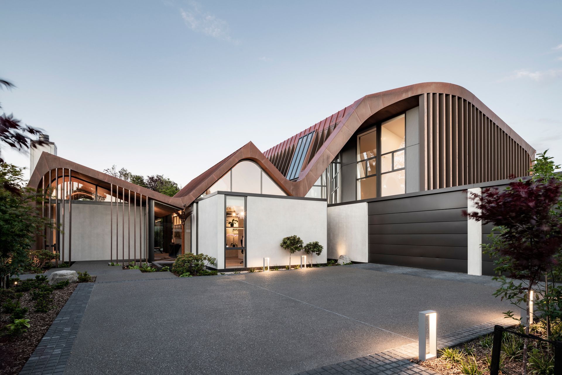 The new home for a retired couple by Craig South of South Architects in Christchurch. Design work was already underway when the homeowners suggested adding curves to the roofline. “The form changed slightly,” says Craig, “but the concept of the three concrete pavilions stayed.”