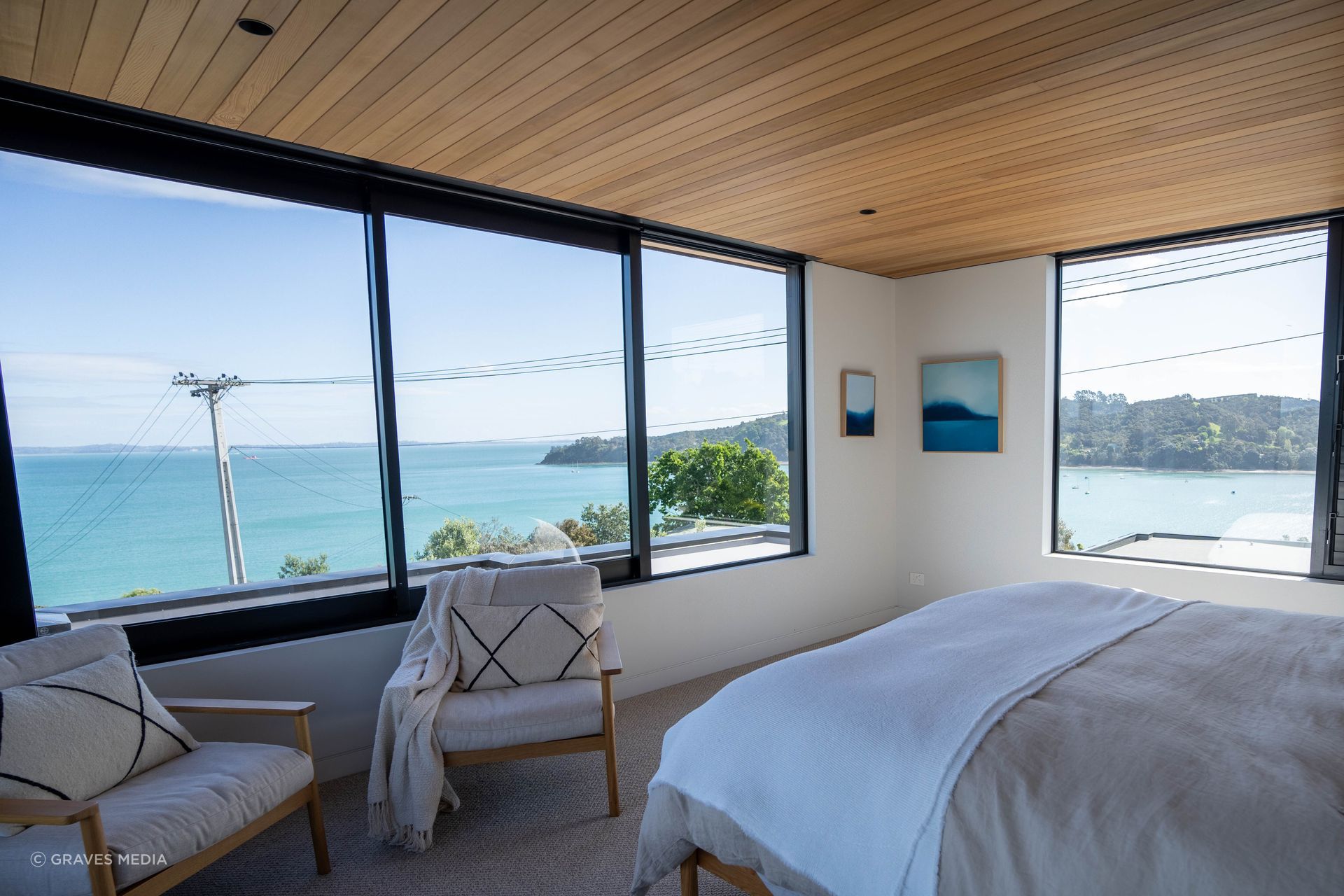  Large sliding windows welcome in the ocean breeze and furniture and textiles have been carefully selected to complement the cedar sarking and surrounding environment.