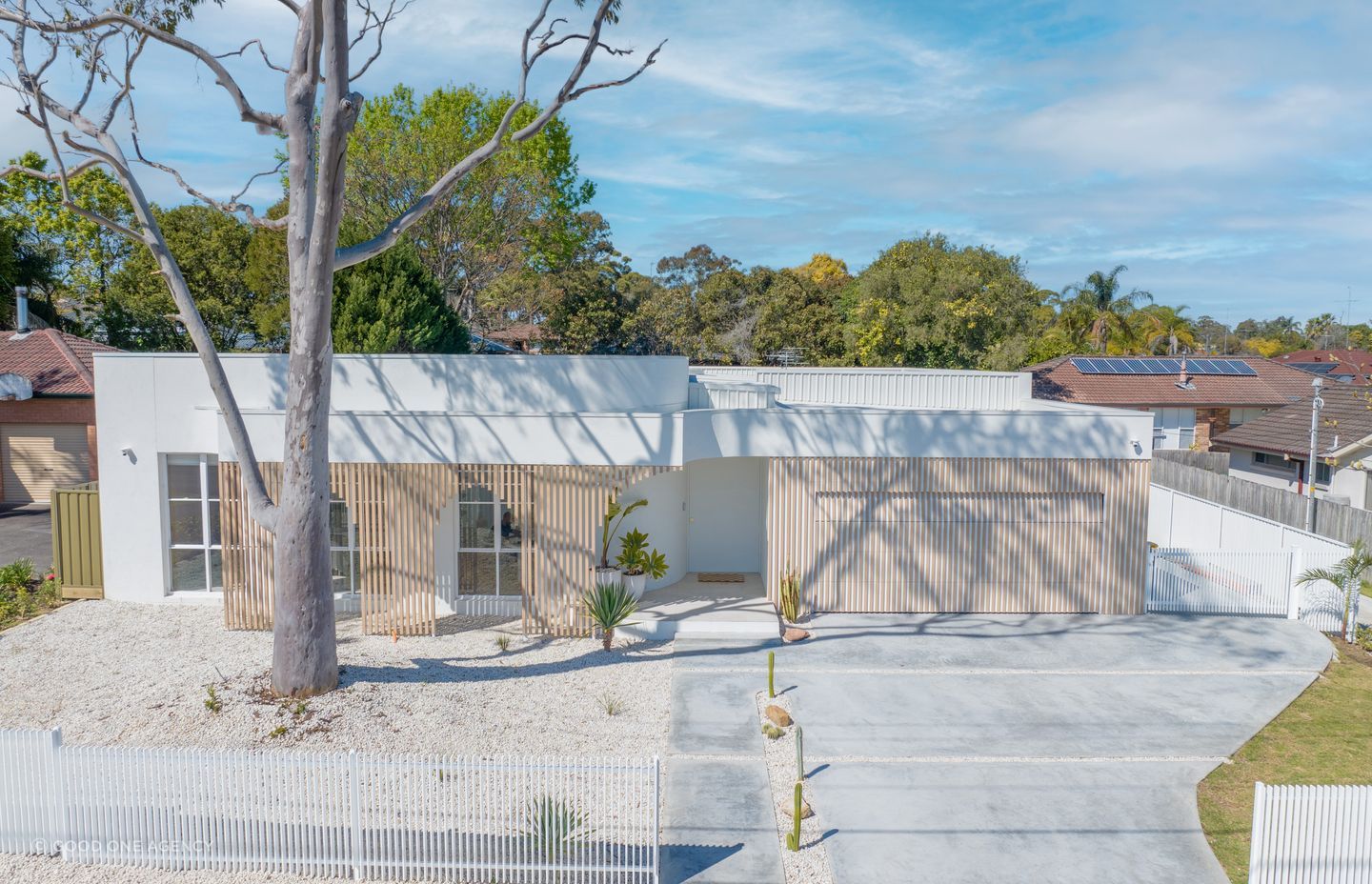 The pale exterior palette reflects the Mediterranean aesthetic.