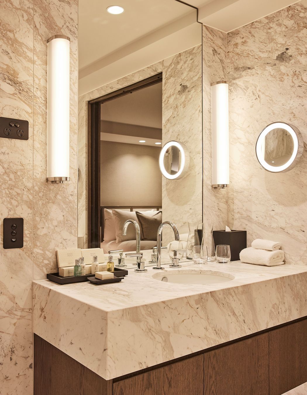 The hotel's rooms' ensuites are palatial in size and feature soft marble, contrasted against rich oak veneer.