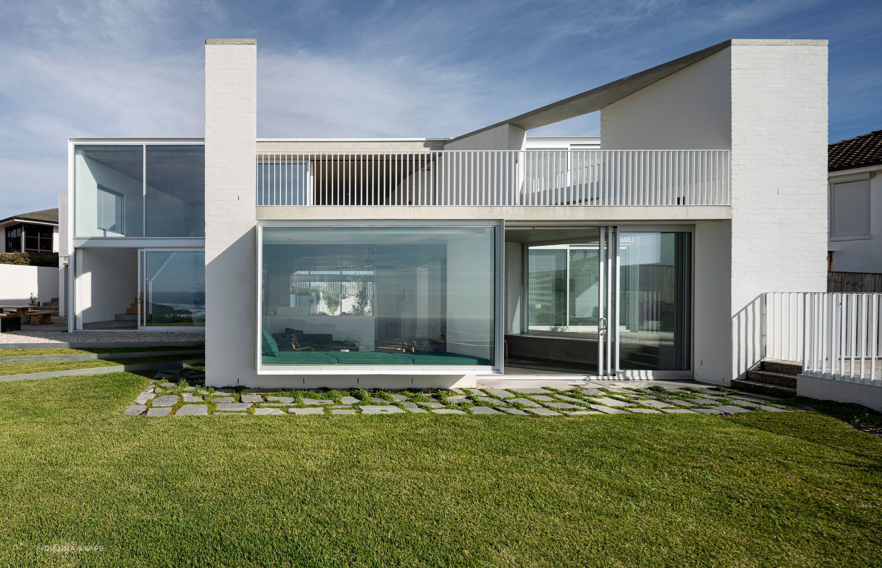 The form of the home follows the line of the section, which is narrower at the driveway end and widens towards the sea views.