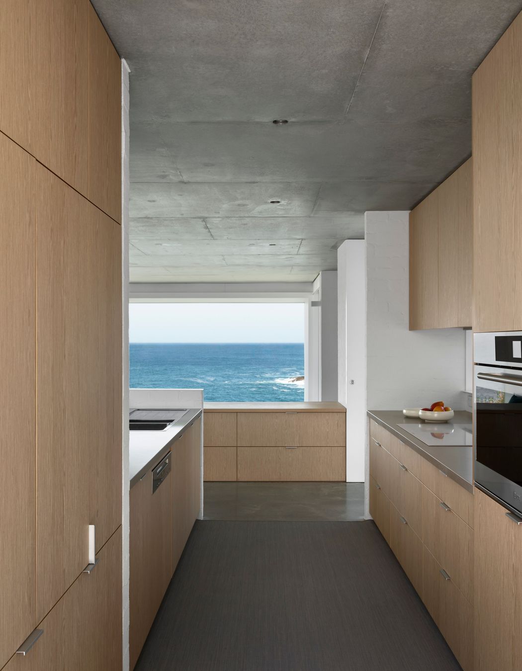 The simplicity of the galley-style kitchen promotes a sense of spaciousness and connection with the view.