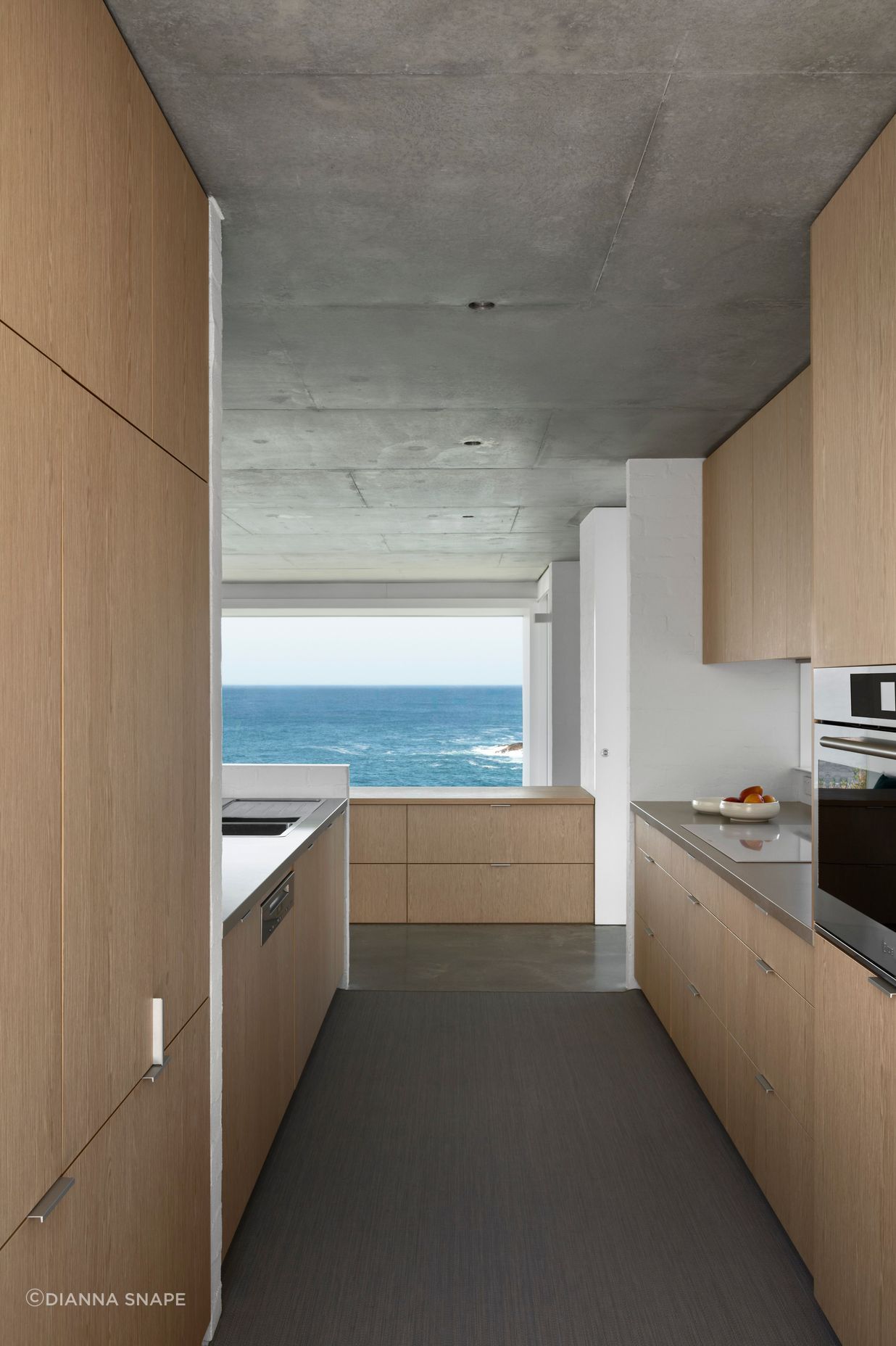 The simplicity of the galley-style kitchen promotes a sense of spaciousness and connection with the view.