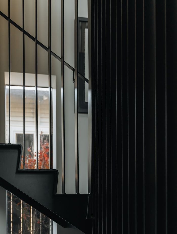 A batten steel balustrade welcomes natural light into the rest of the home.