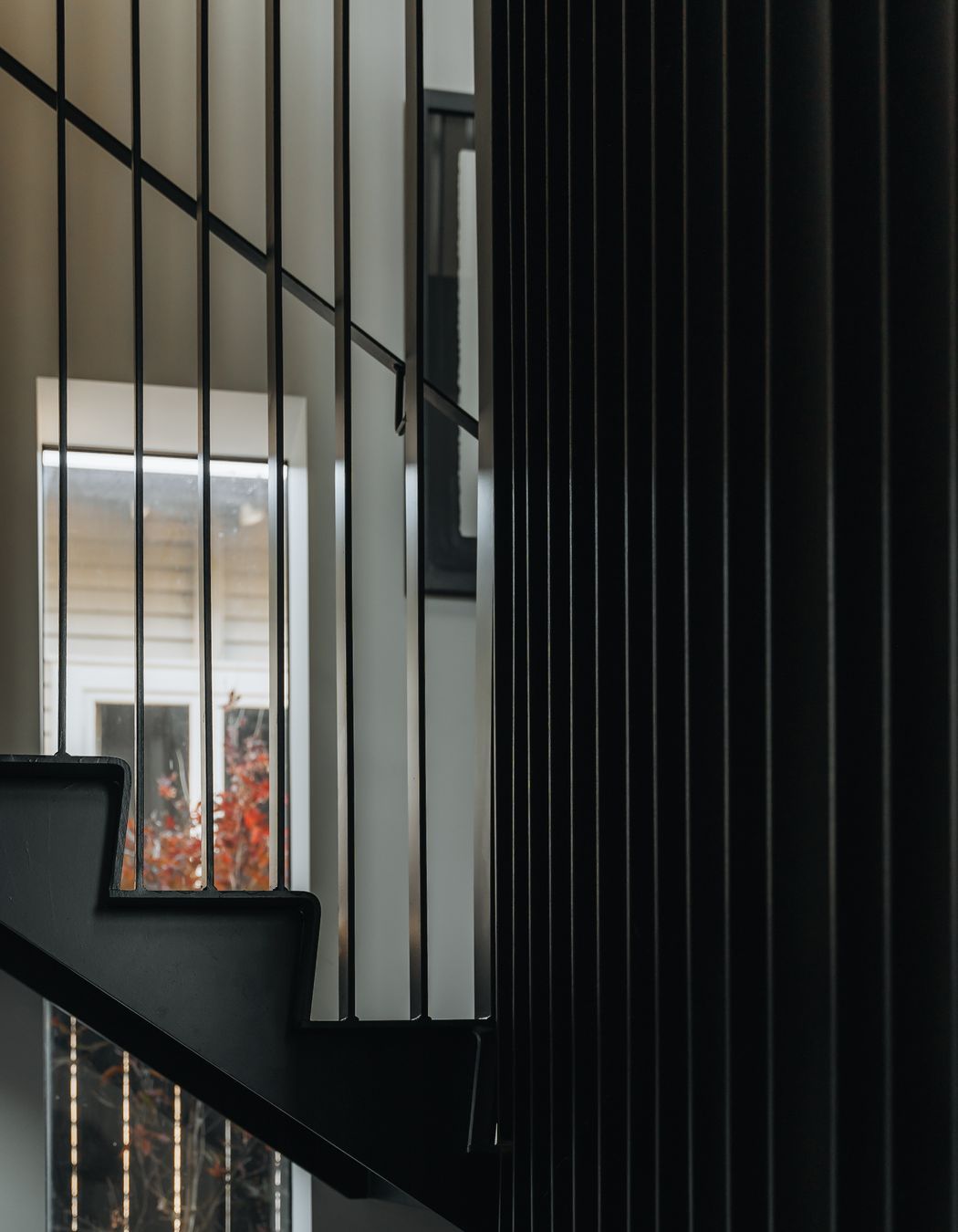 A batten steel balustrade welcomes natural light into the rest of the home.