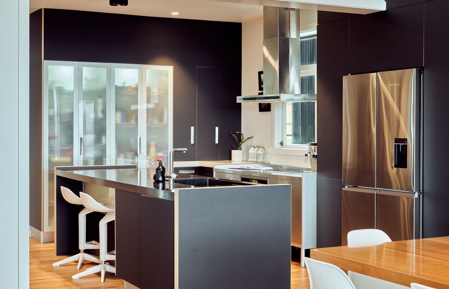 The dark, recessive kitchen is a show-stopping centrepiece.
