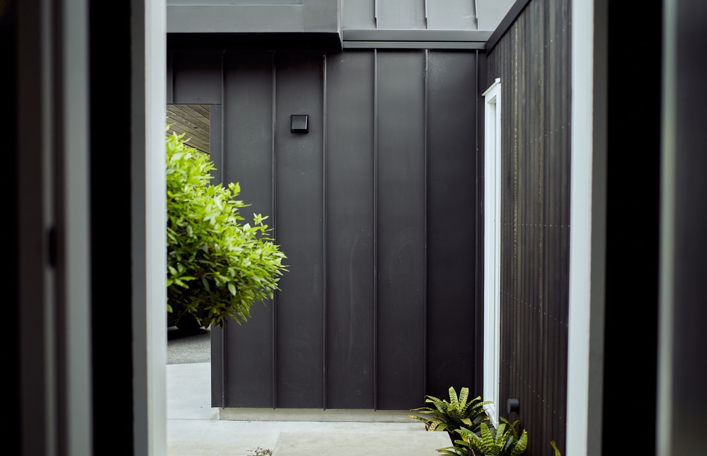 Steel tray cladding interconnects easily with stained cedar and weatherboard.