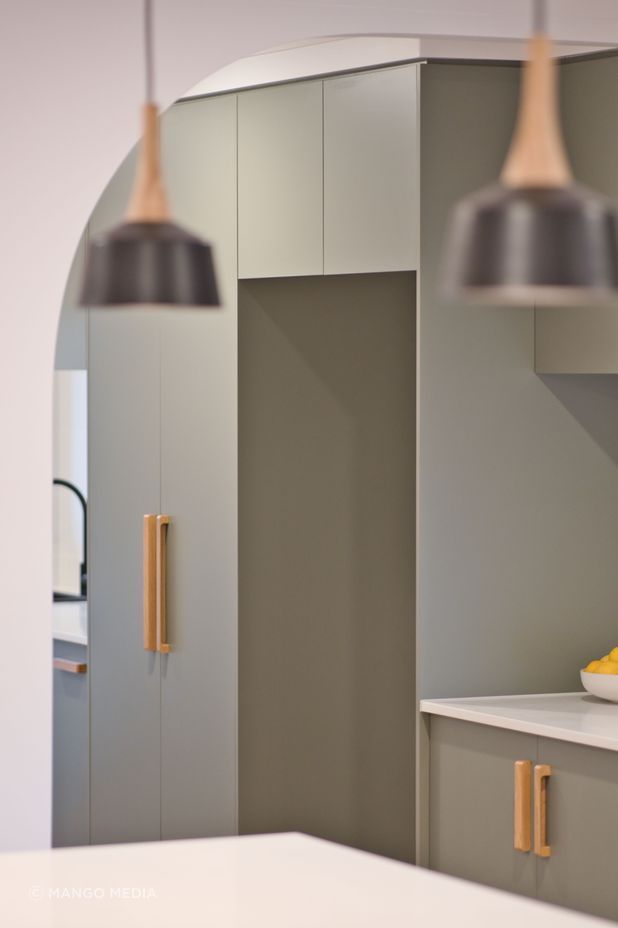 "Everyone wants that coastal feel, and they’ve done this in a modern way with flat kitchen cupboard panels and sage green which makes a big impact."