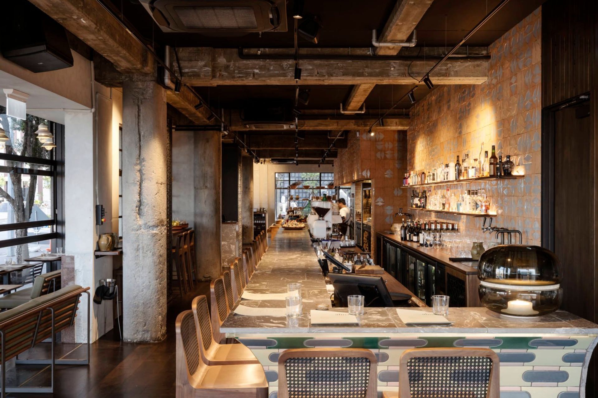 The heritage-listed external wall, which is now internal, is marked by a row of concrete columns that have been left raw.