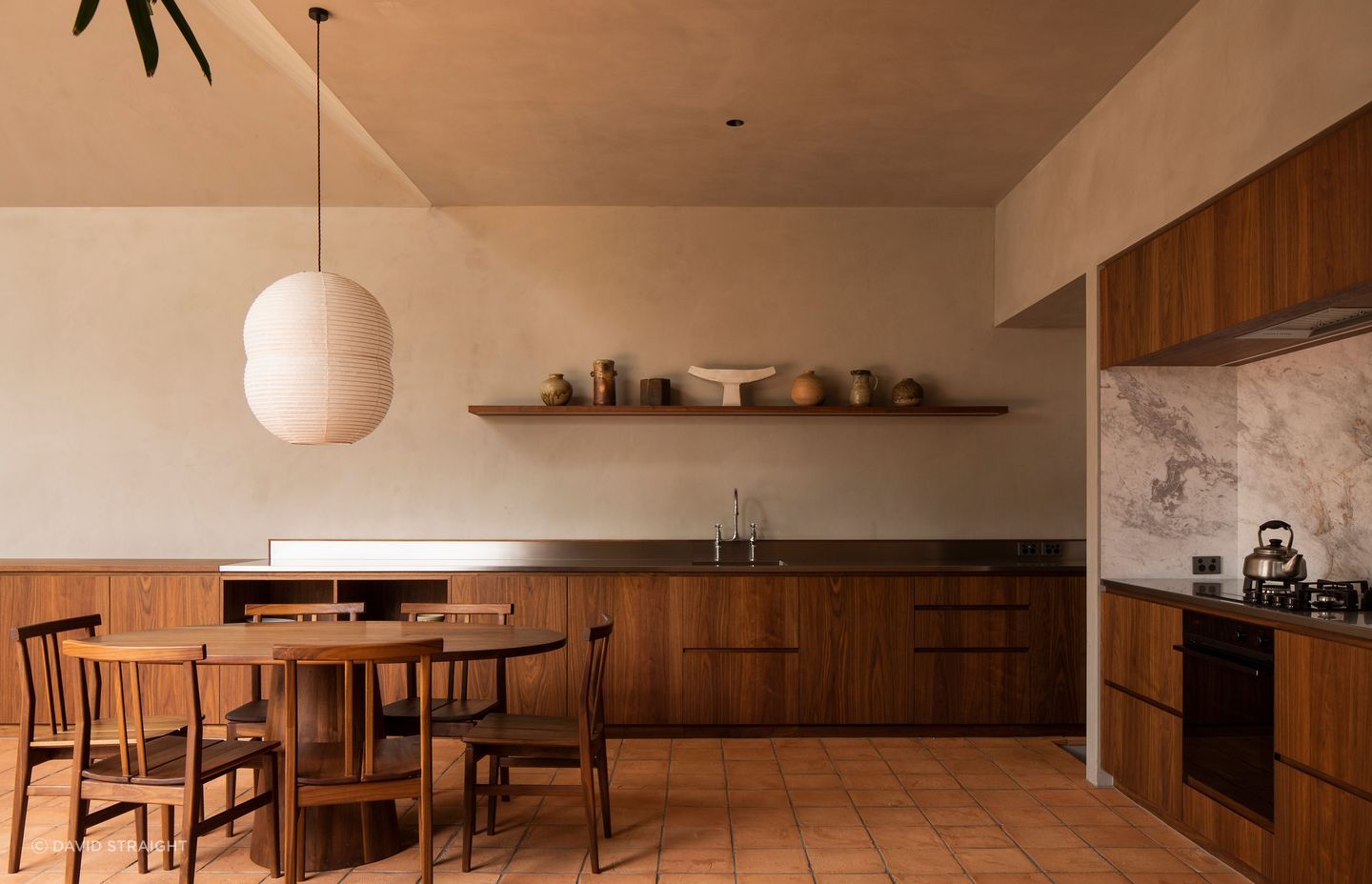 The kitchen area wraps around a corner of the extension. The walls are finished with Resene Rockcote Otsumigaki, a system in the tradition of lime and clay based Japanese plasters.