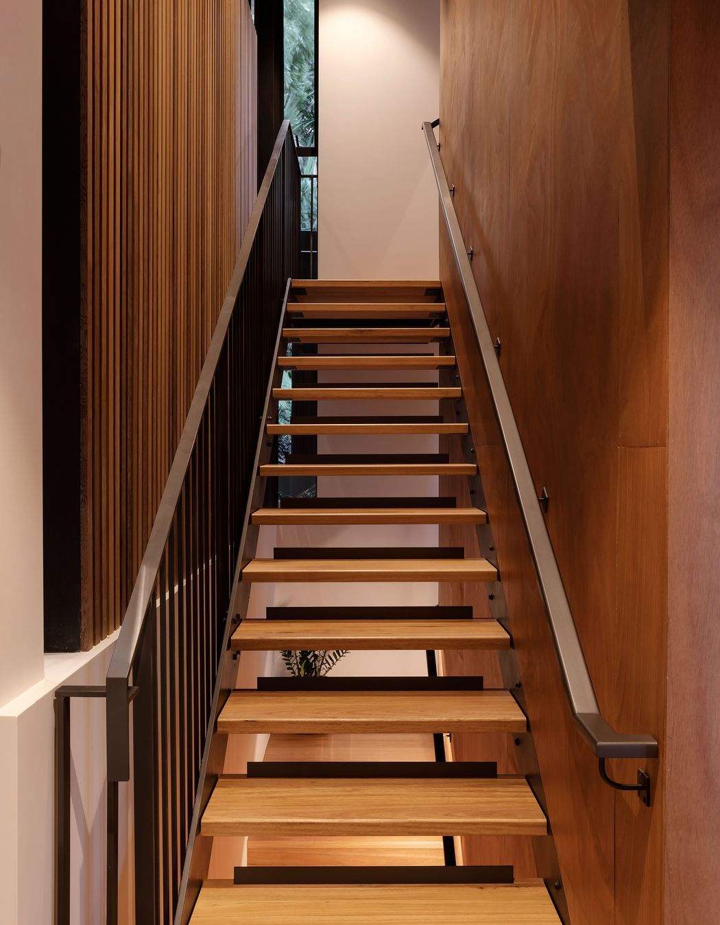 The open treads of the stairs to the main bedroom let light through. There is also a platform lift in the house: convenient now and for easier upstairs access if needed in the future.