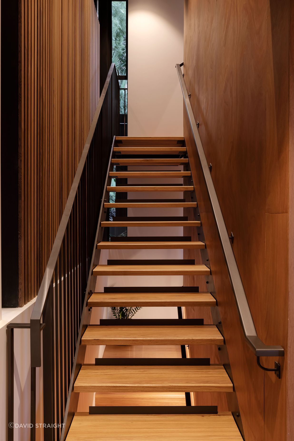 The open treads of the stairs to the main bedroom let light through. There is also a platform lift in the house: convenient now and for easier upstairs access if needed in the future.